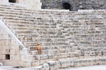 Royalty Free Photo of a Woman on the Ancient Steps of the Amphitheatre at Beit-Shean